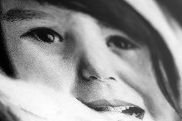 Charcoal illustration close-up of little Eskimo girl's face